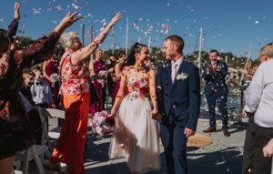 Bride and Groom entering a flurry of confetti