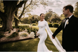 bride and groom walking through a tasmanian garden venue