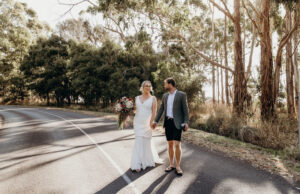 bride and groom waling down tasmanian road