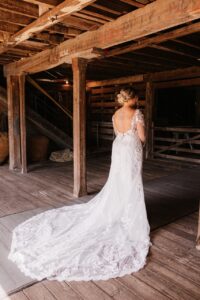 bride in rustic barn before first look